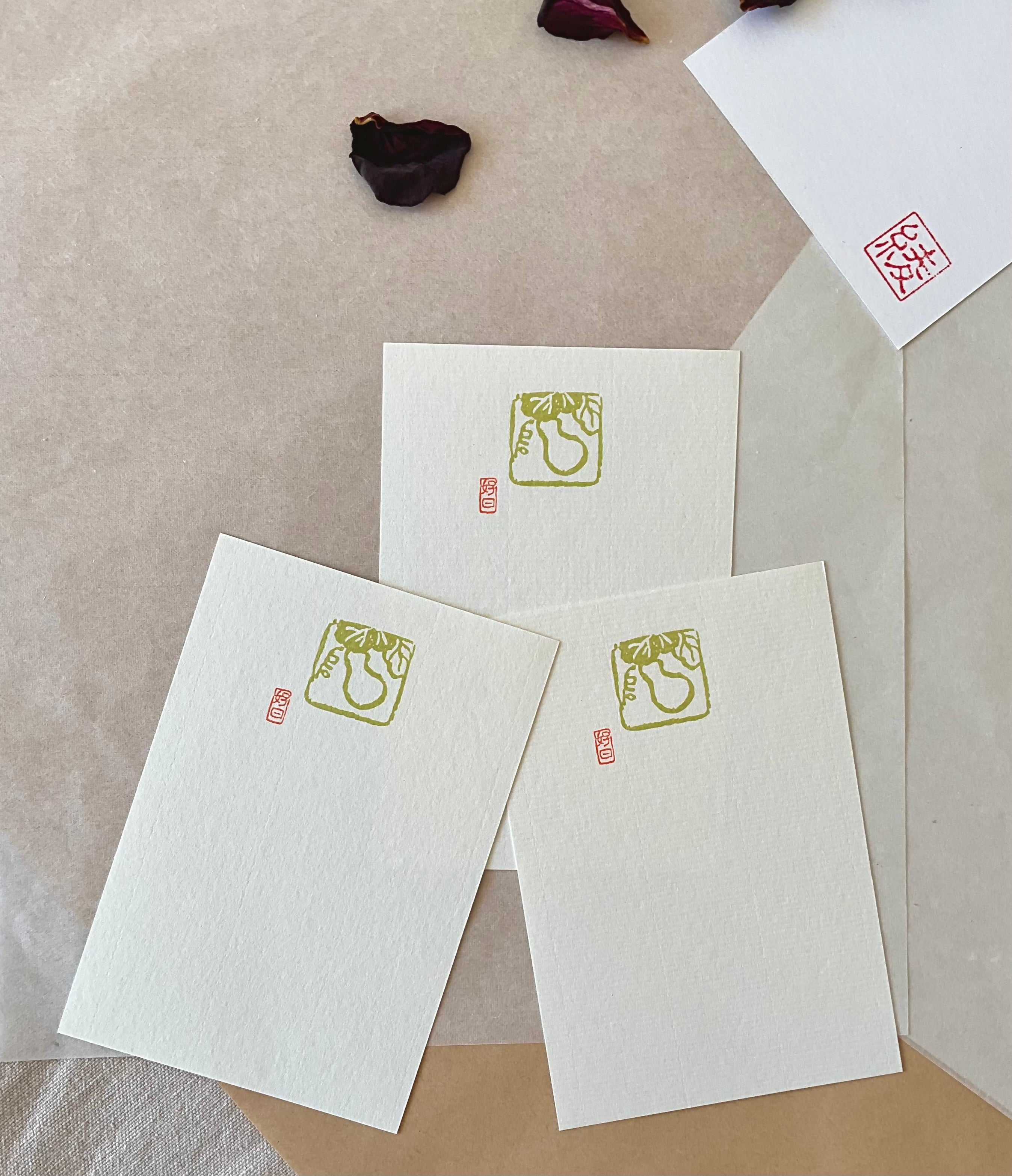Three Genro gourd postcards fanned out on layered paper with Aya hanko stamp in corner