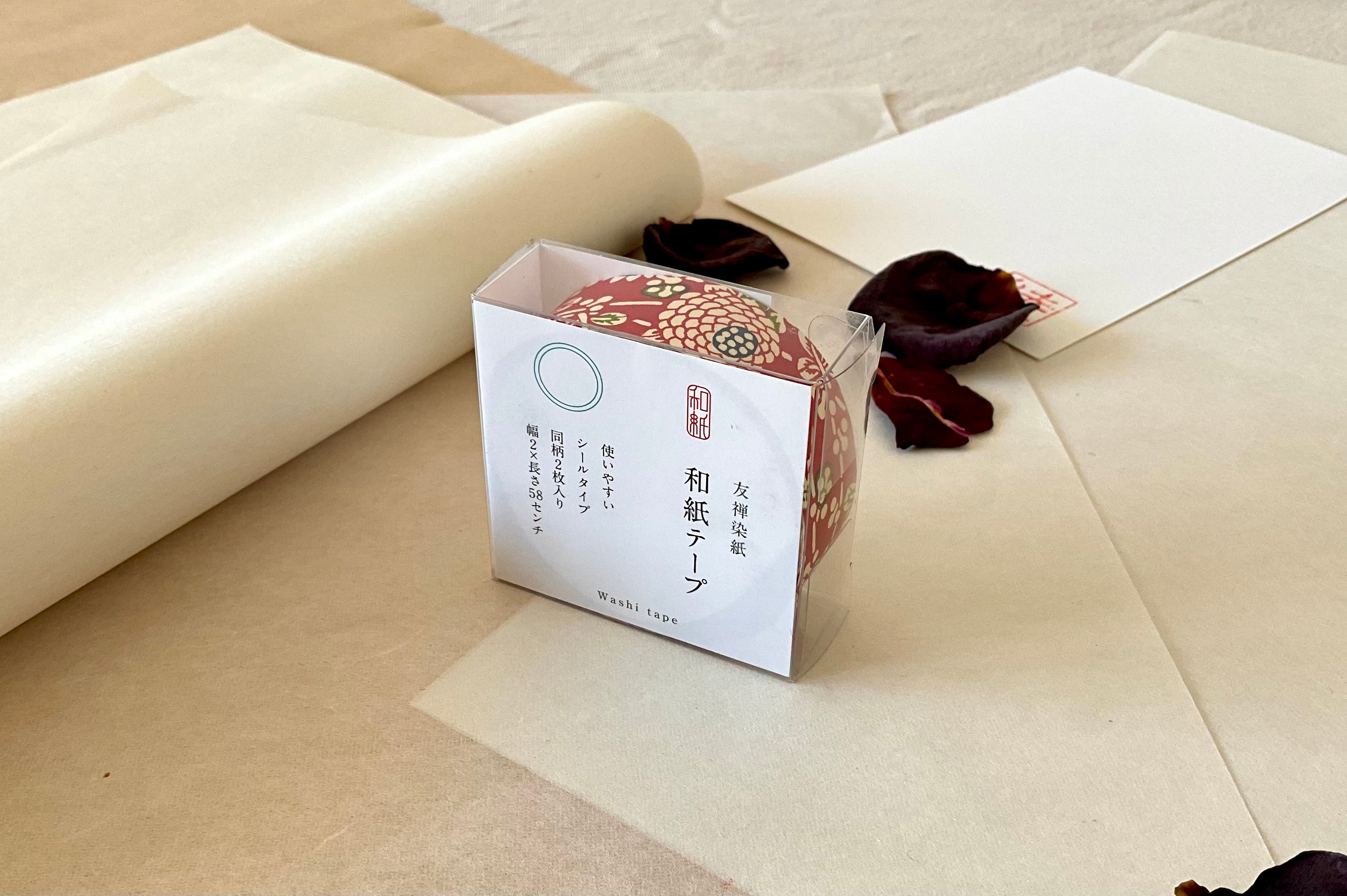 Sealed Shogado yuzen washi tape box with Japanese product label reading washi tape, two sheets same pattern, 2cm by 58cm, Crimson red with cream chrysanthemum and floral motifs, navy dotted circle centers, green accents, on layered washi paper with dried rose petals