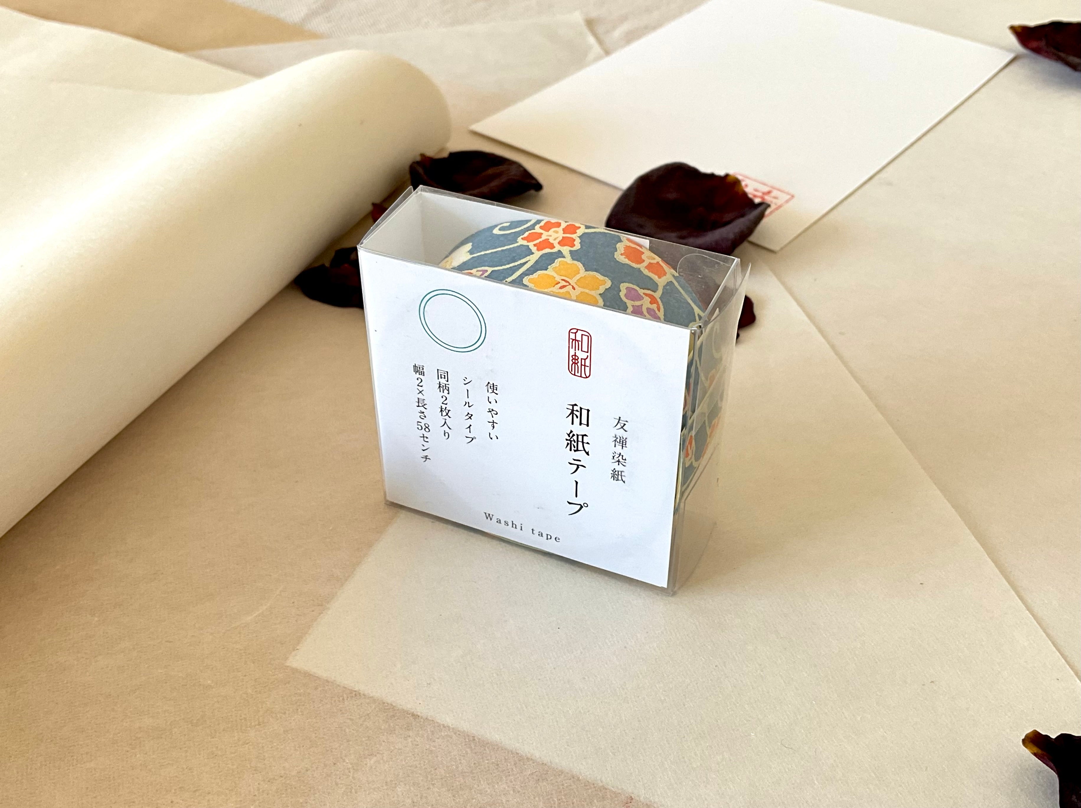 Sealed Shogado yuzen washi tape box with Japanese product label reading washi tape, two sheets same pattern, 2cm by 58cm, Steel blue with yellow, orange, purple small florals, on layered washi paper with dried rose petals