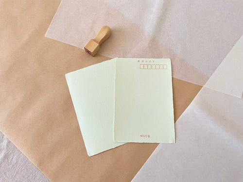 Kyukyodo green washi postcard pair showing soft mint color and deckled edges on washi paper