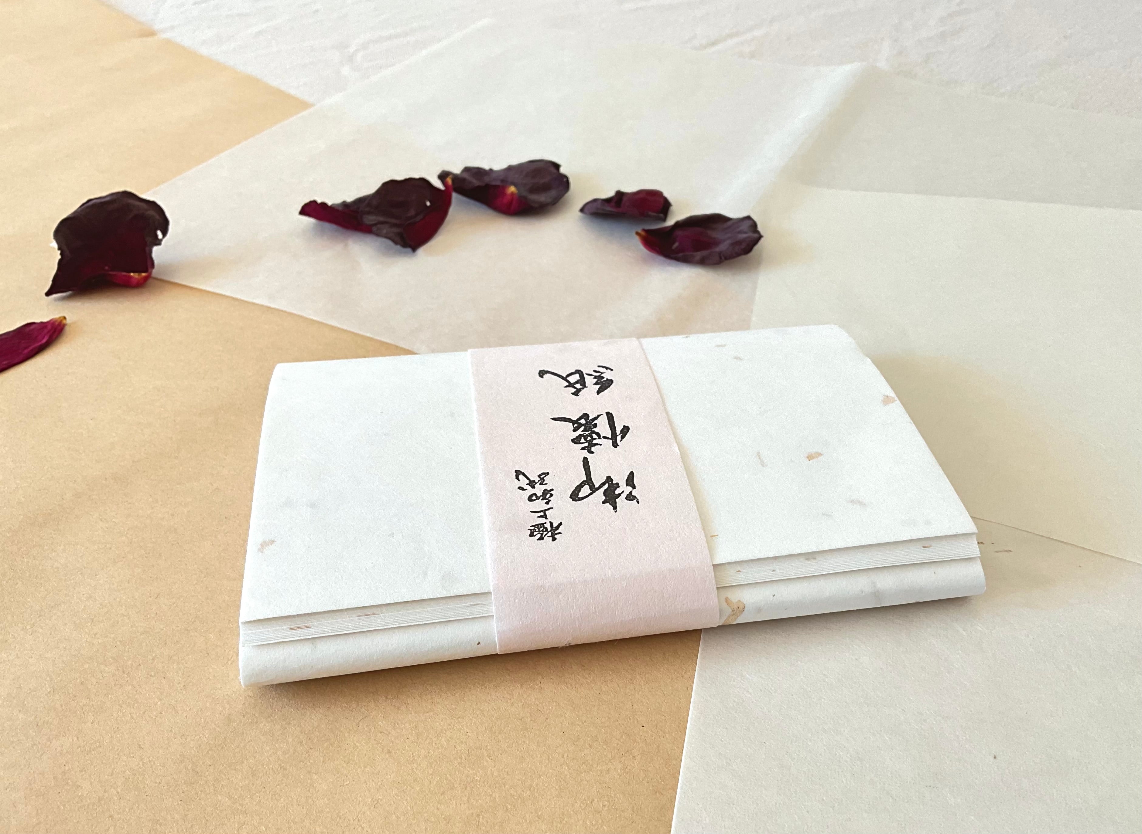 Unryu sunago washi paper stack showing translucent kozo fiber texture and metallic leaf detail