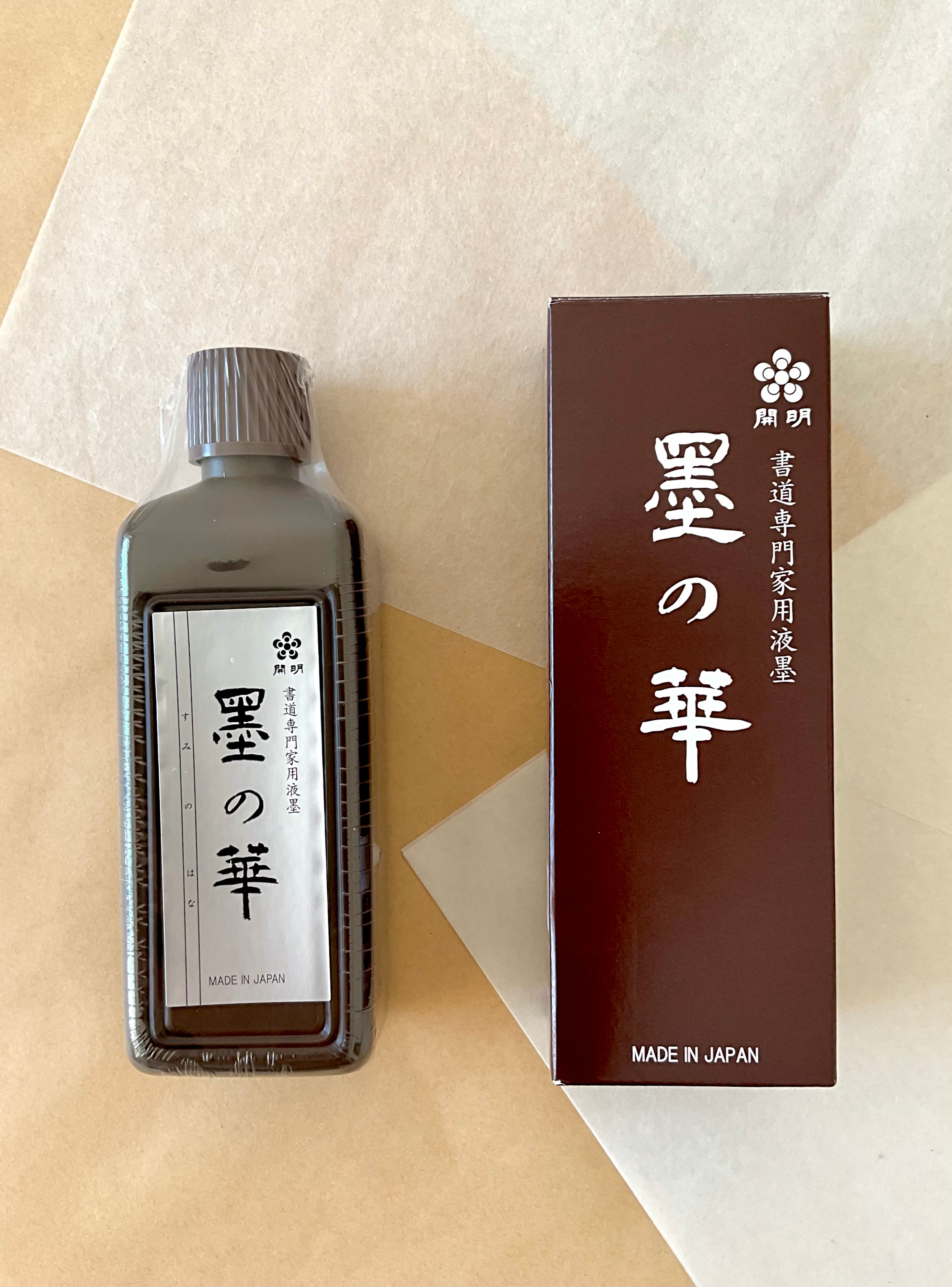 Kaimei Sumi no Hana 200ml ink bottle beside original dark red packaging box on neutral paper