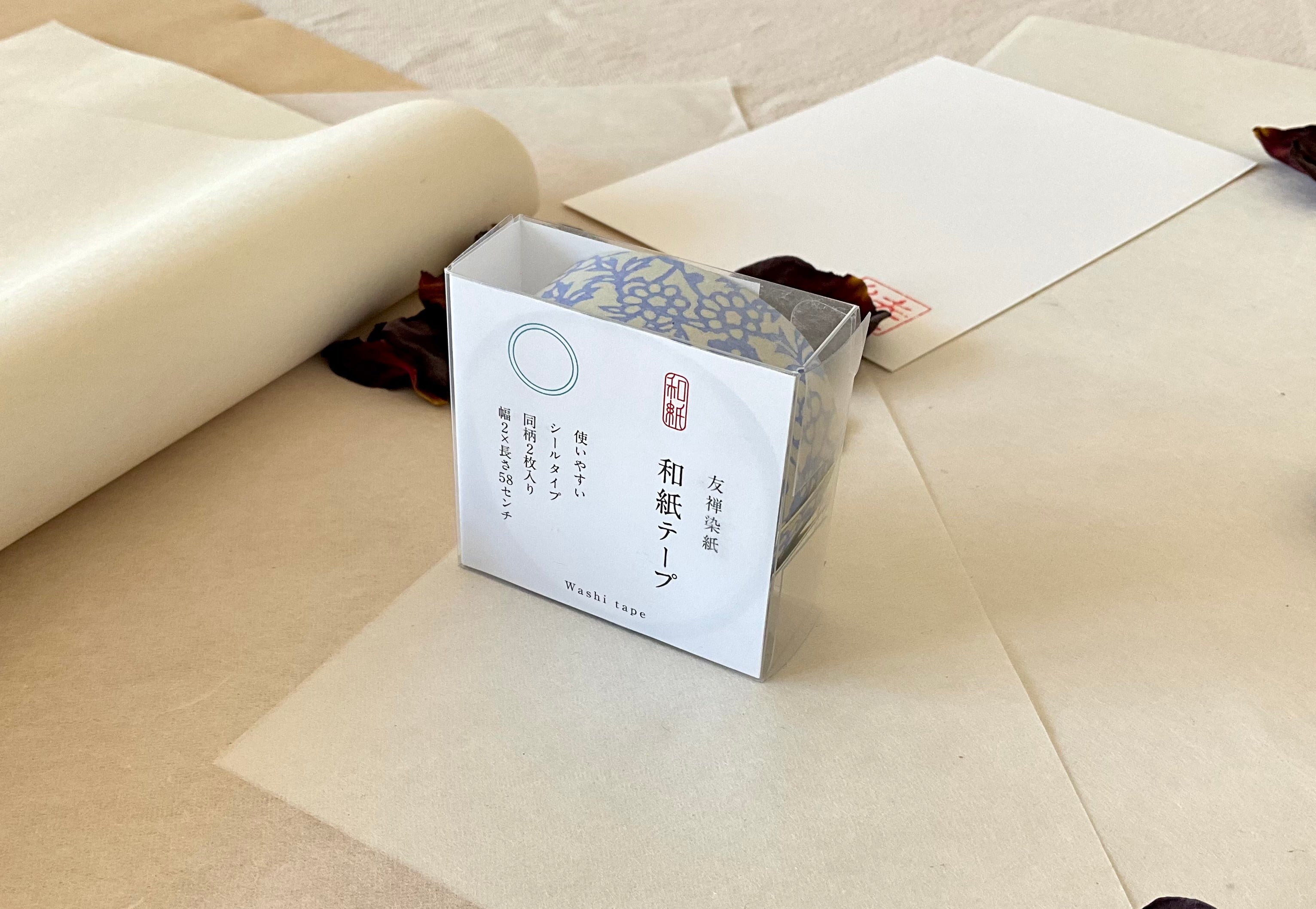 Sealed Shogado yuzen washi tape box with Japanese product label reading washi tape, two sheets same pattern, 2cm by 58cm, Grey-blue with blue floral block print pattern, on layered washi paper with dried rose petals