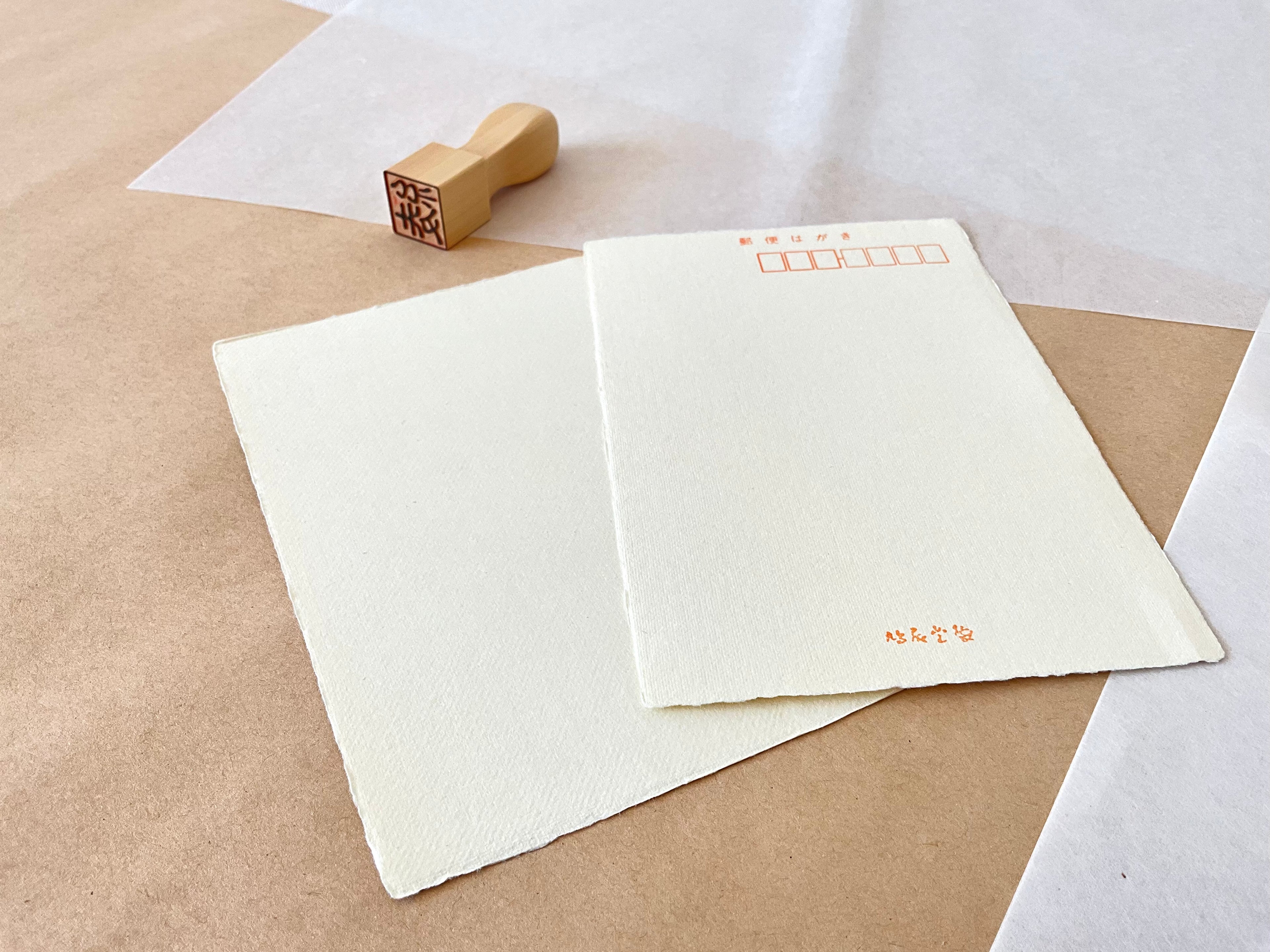 Kyukyodo yellow washi postcard front and back on layered washi paper with hanko stamp beside