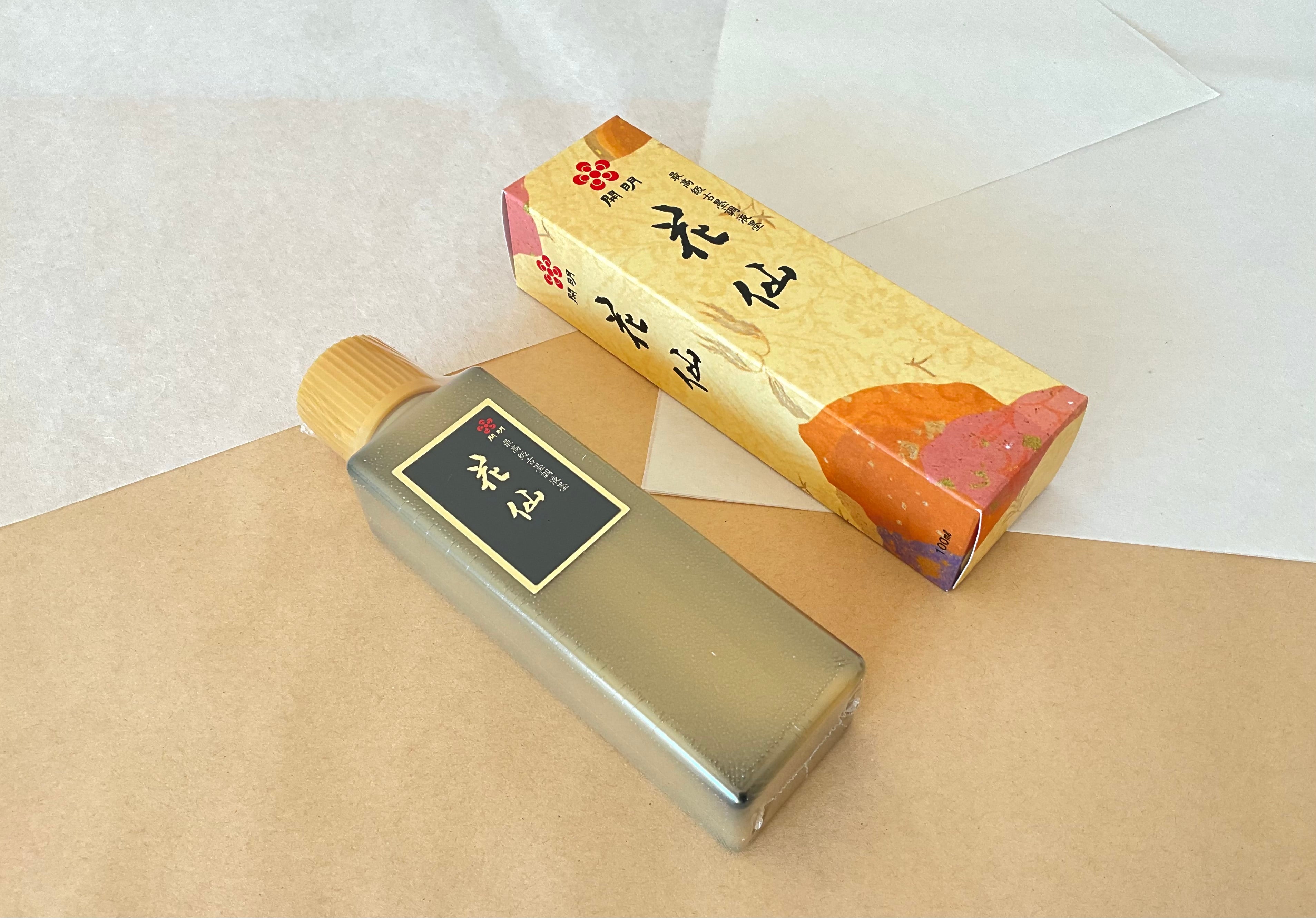 Kaimei Kasen 100ml olive-tone bottle beside gold floral presentation box on kraft paper