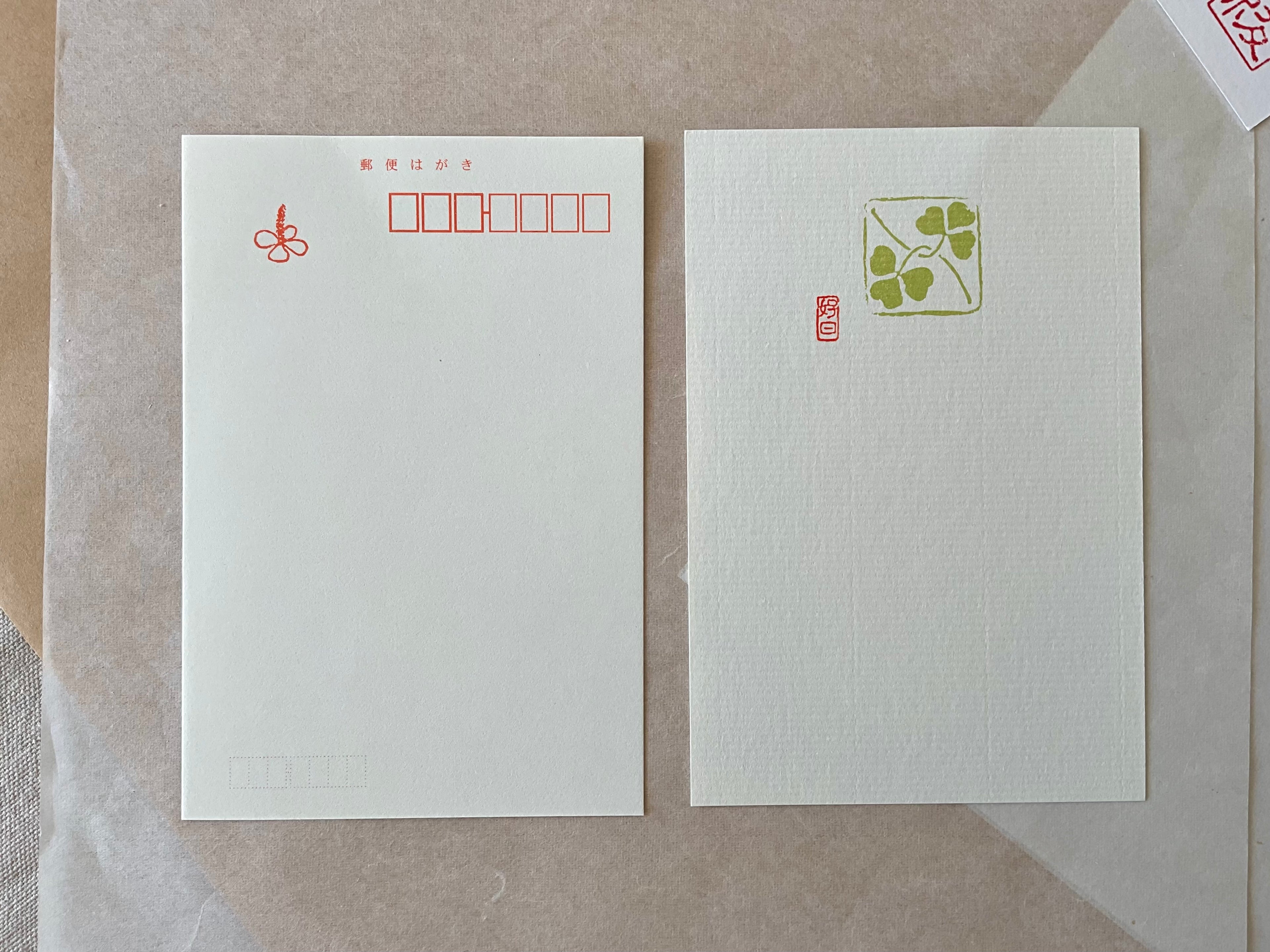 Genro clover postcard front and back side by side on layered paper background