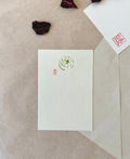 Genro Kojitsu Hagaki tsubame swallow postcard with olive green bird in leaves illustration and red seal stamp