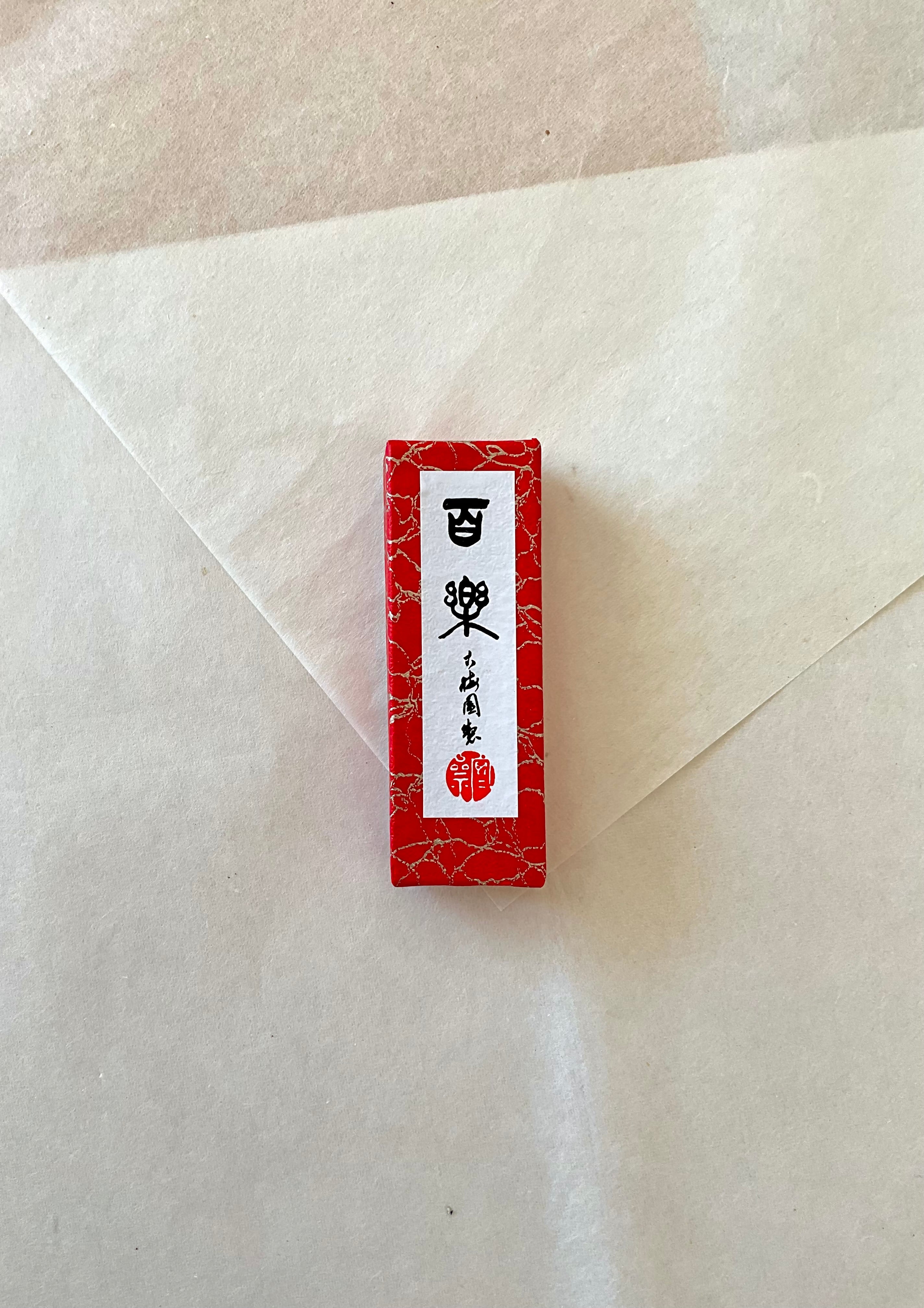 Hyoraku ink stick by Kobaien in red marbled presentation box on neutral background
