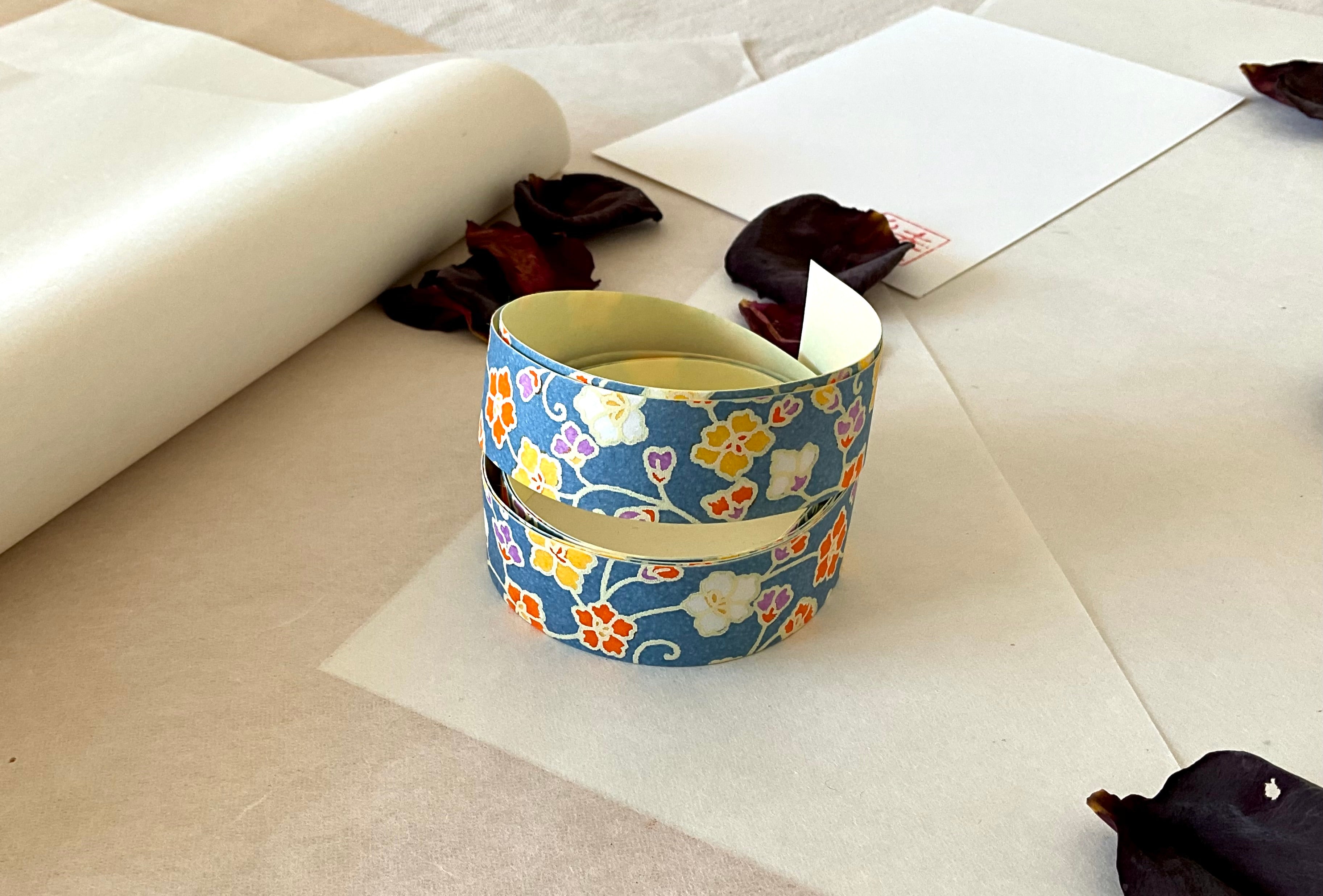 Sealed Shogado yuzen washi tape box with Japanese product label reading washi tape, two sheets same pattern, 2cm by 58cm, Cobalt blue with white, pink and pale blue cherry blossom branches, on layered washi paper with dried rose petals