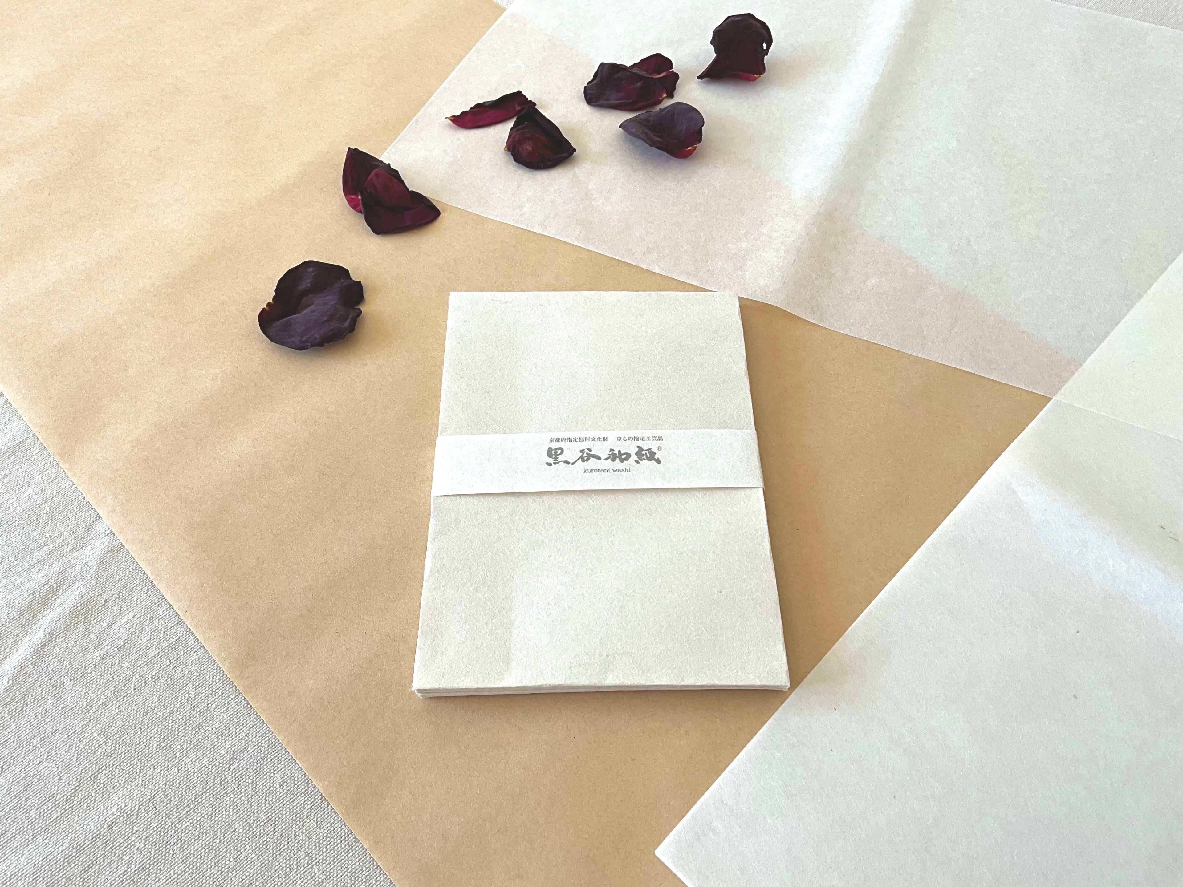 Kurotani washi envelopes fanned showing natural texture and soft white handmade paper