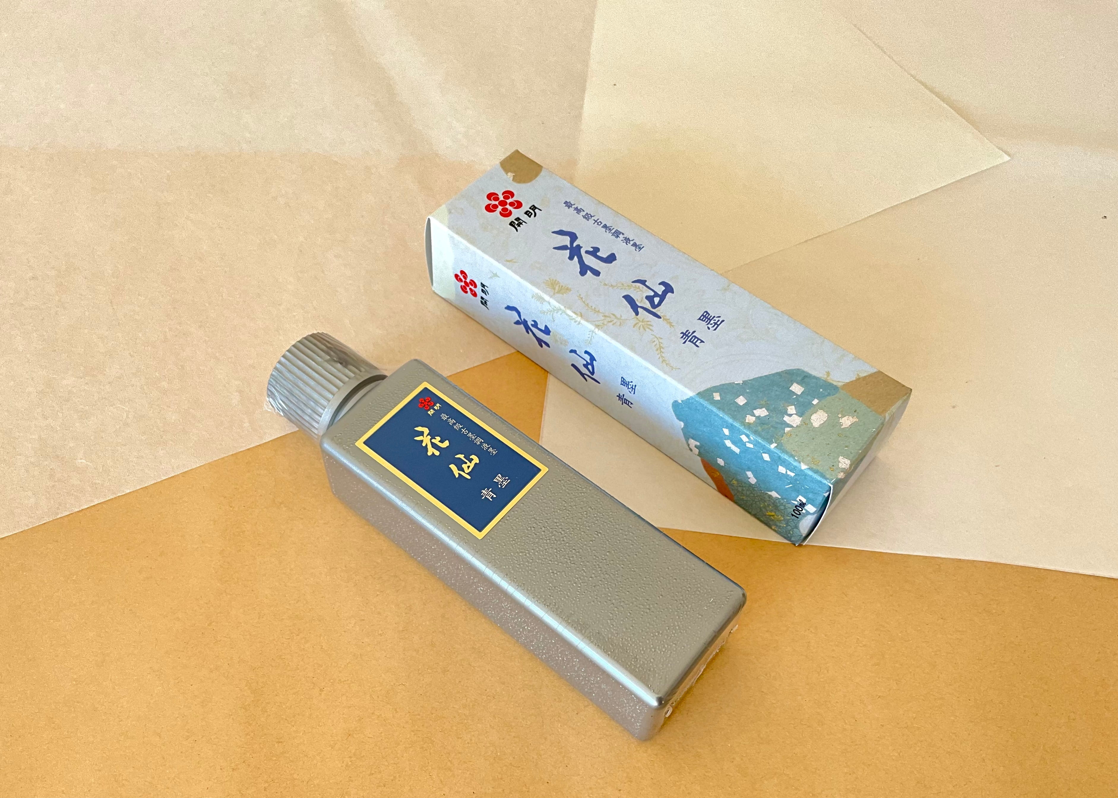Kaimei Kasen Seiboku 100ml silver bottle beside blue floral presentation box on kraft paper