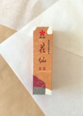 Kaimei Kasen Chaboku brown-black liquid ink in warm orange presentation box on layered washi paper