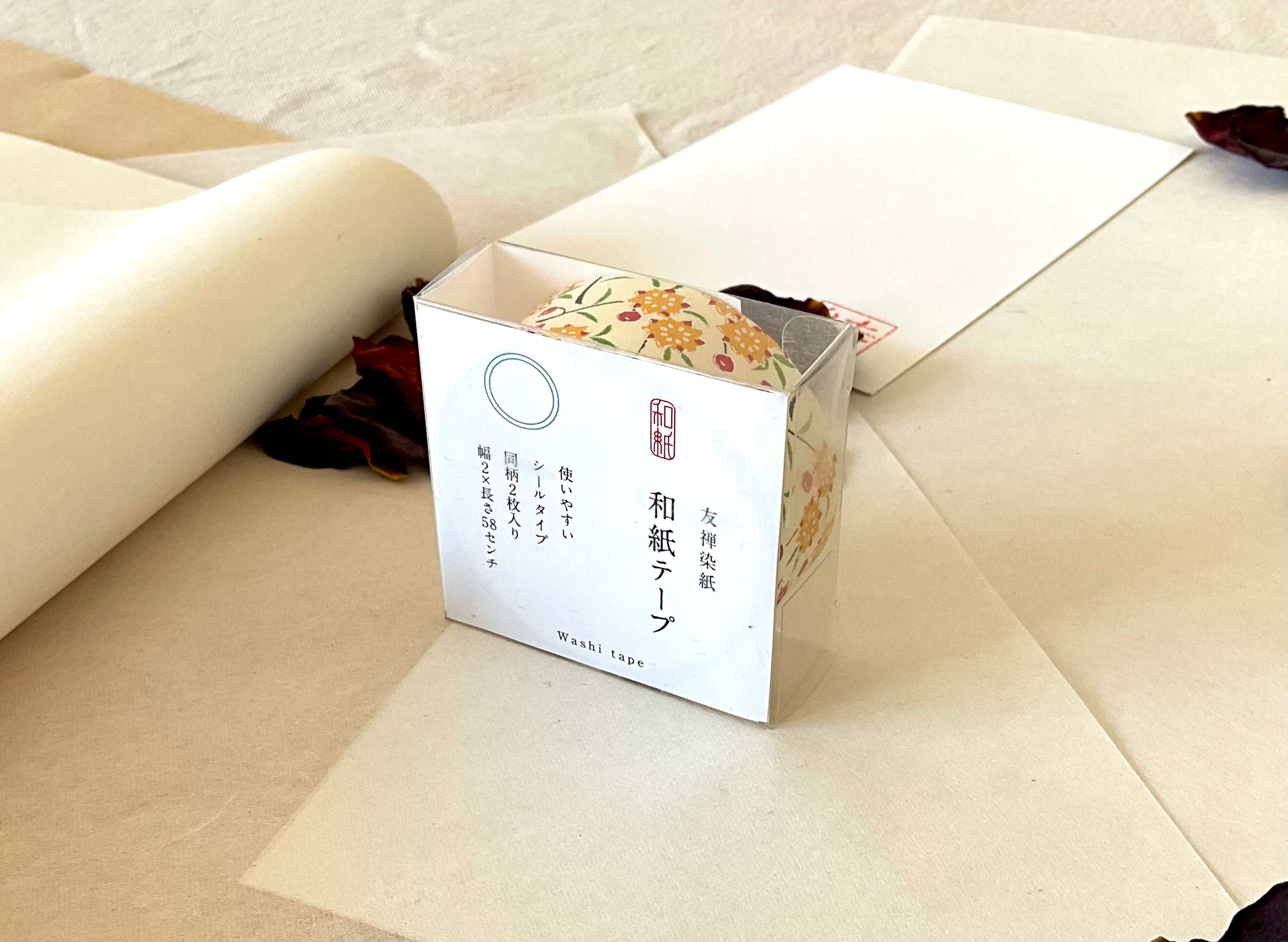 Sealed Shogado yuzen washi tape box with Japanese product label reading washi tape, two sheets same pattern, 2cm by 58cm, Cream with yellow and red floral sprigs, on layered washi paper with dried rose petals