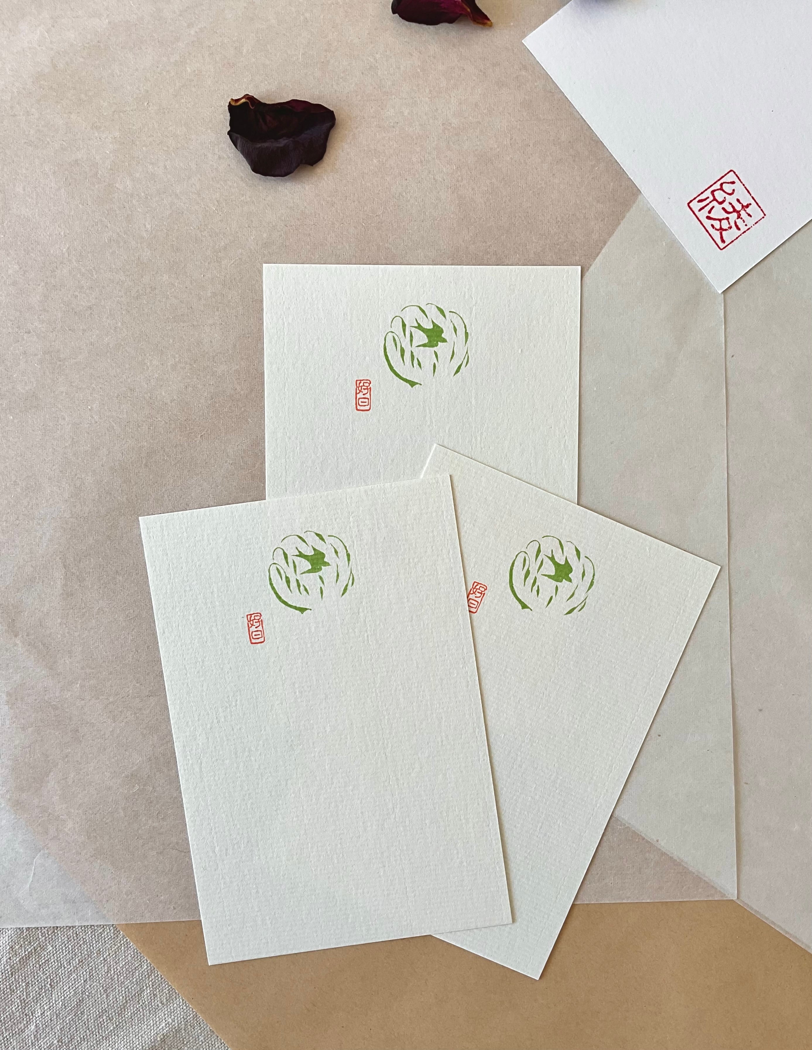 Three Genro swallow postcards fanned out showing consistent olive green illustration on textured paper