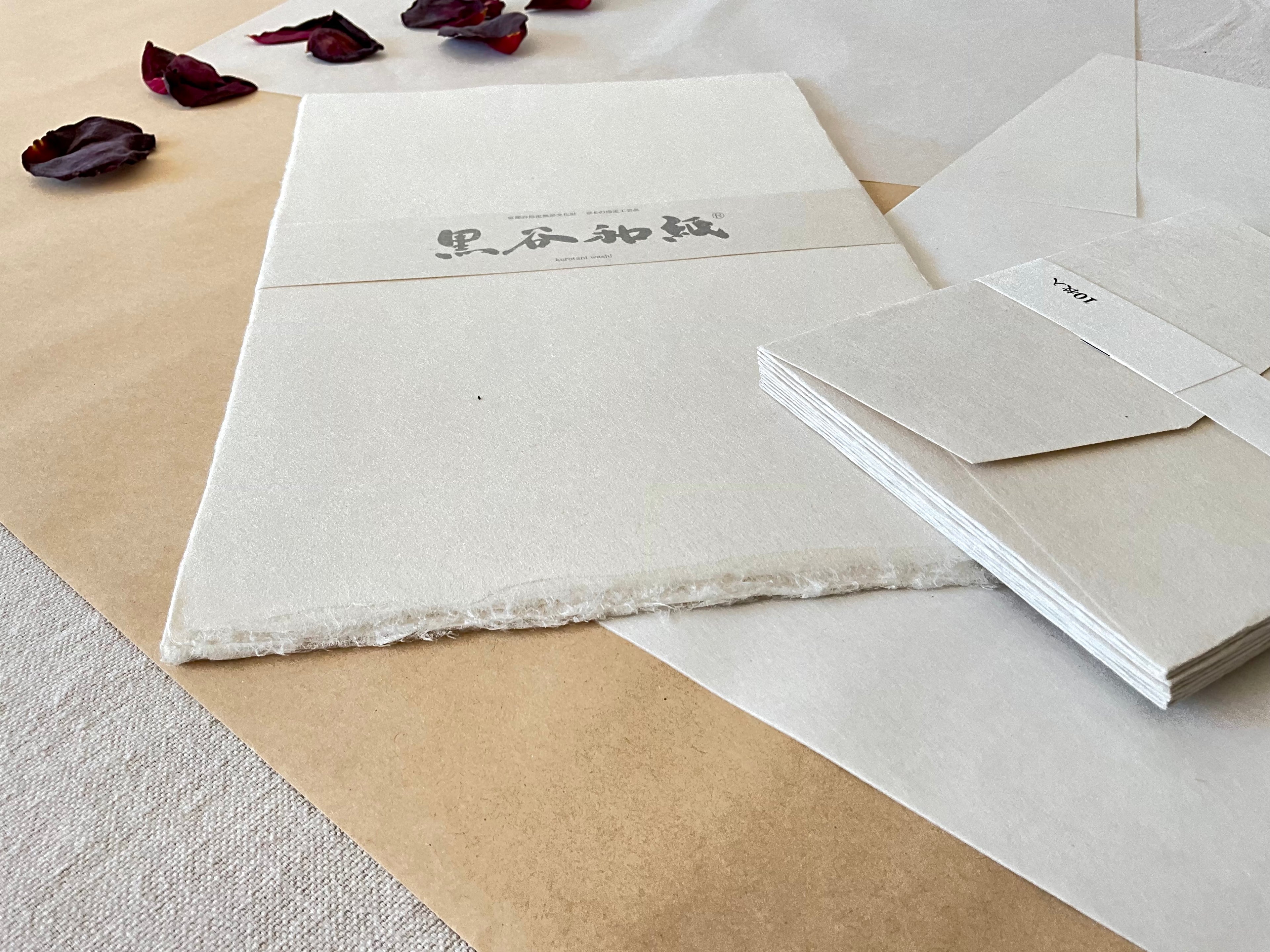 Kurotani washi paper pack showing thick kozo fiber texture and feathered deckled edge detail
